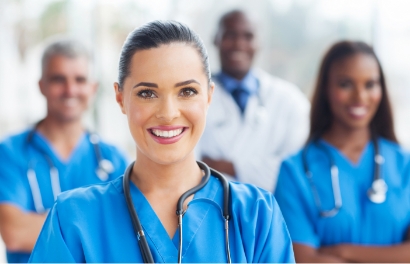 a group of health professionals standing together smiling at the camera