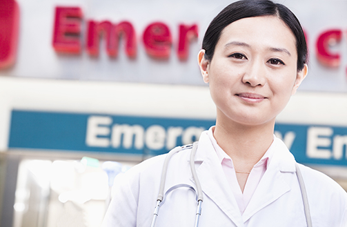 emergency room physician standing in front of emergency department