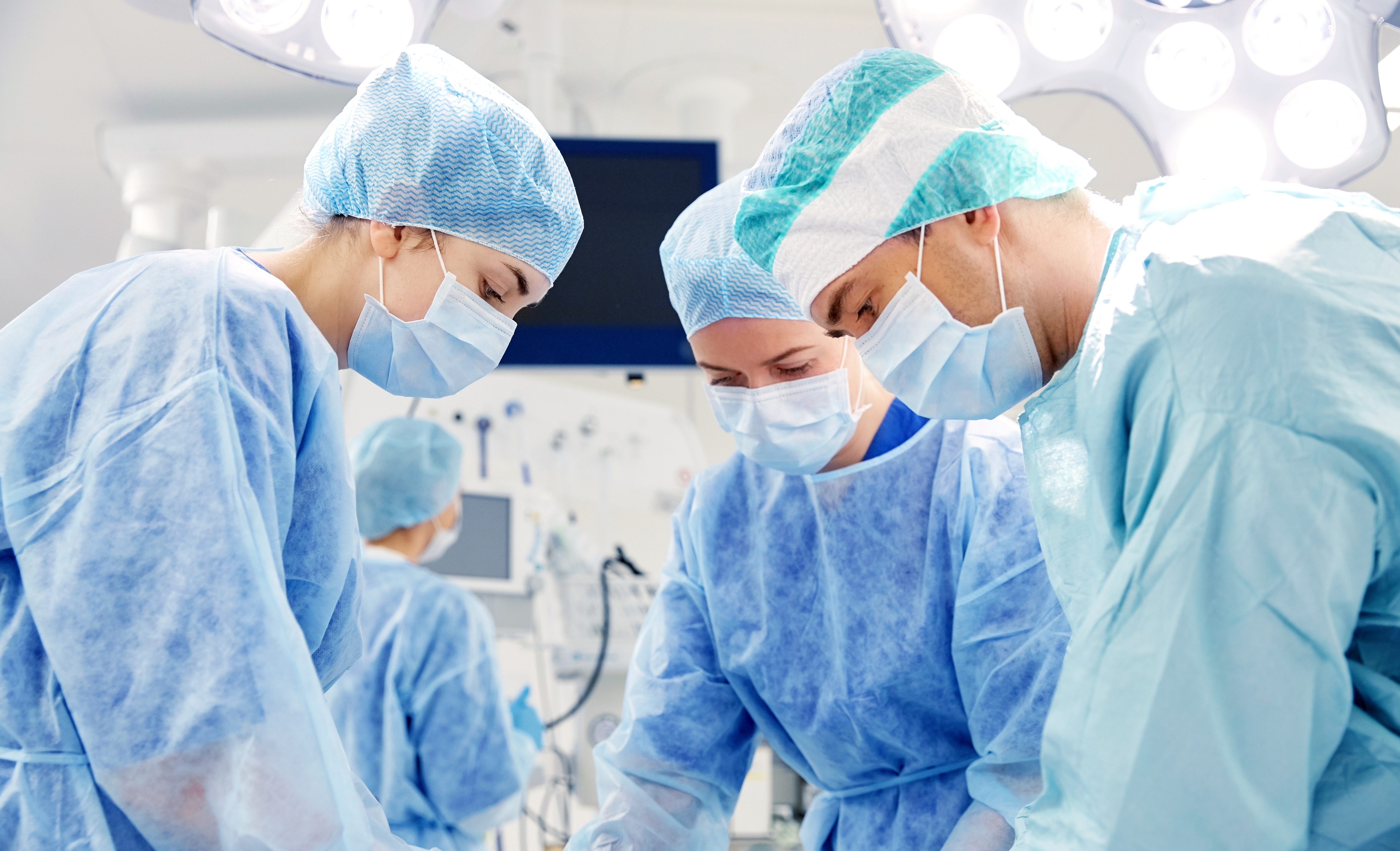 group of surgeons in operating room at hospital