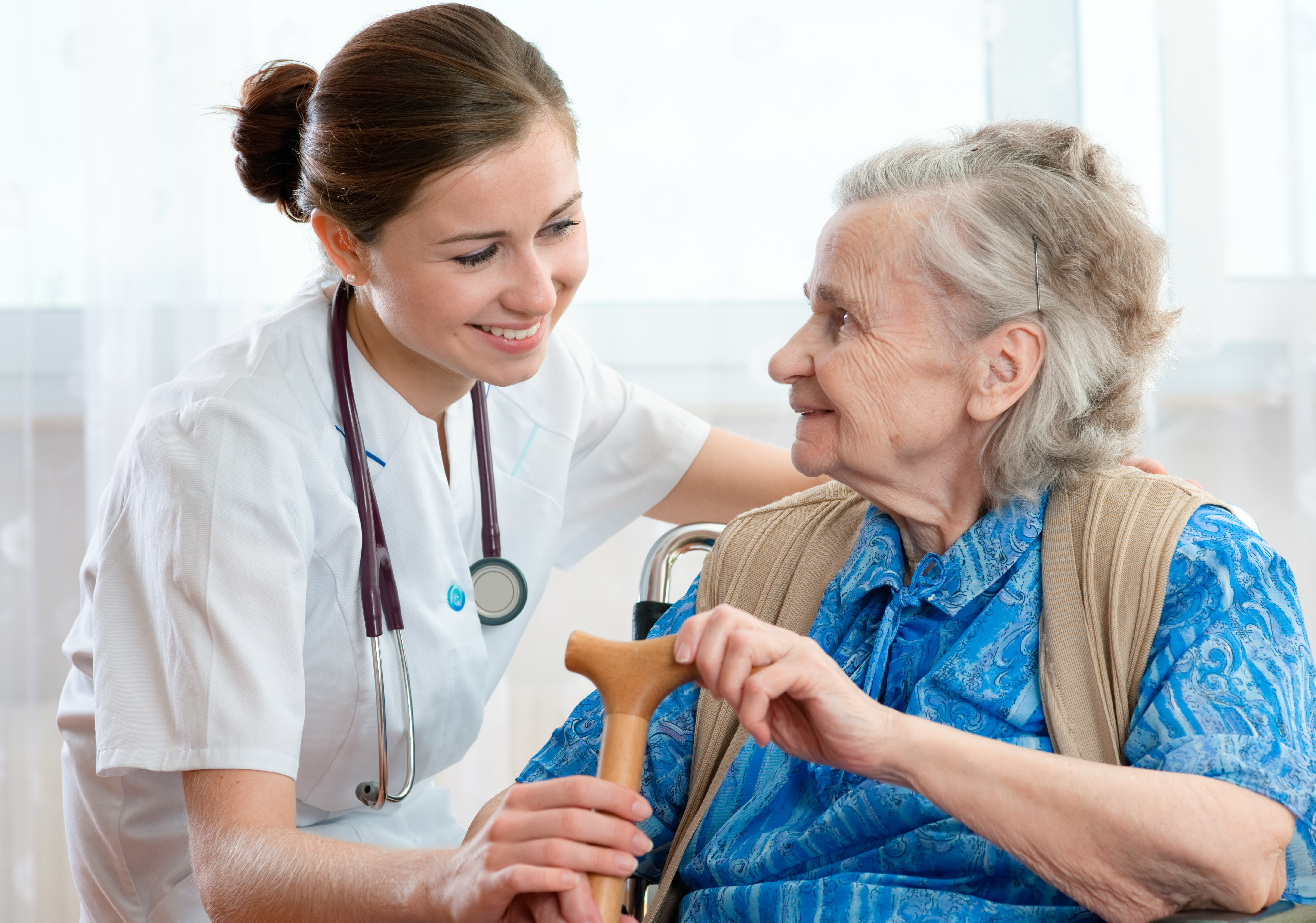 Physician with elderly woman in wheelchair