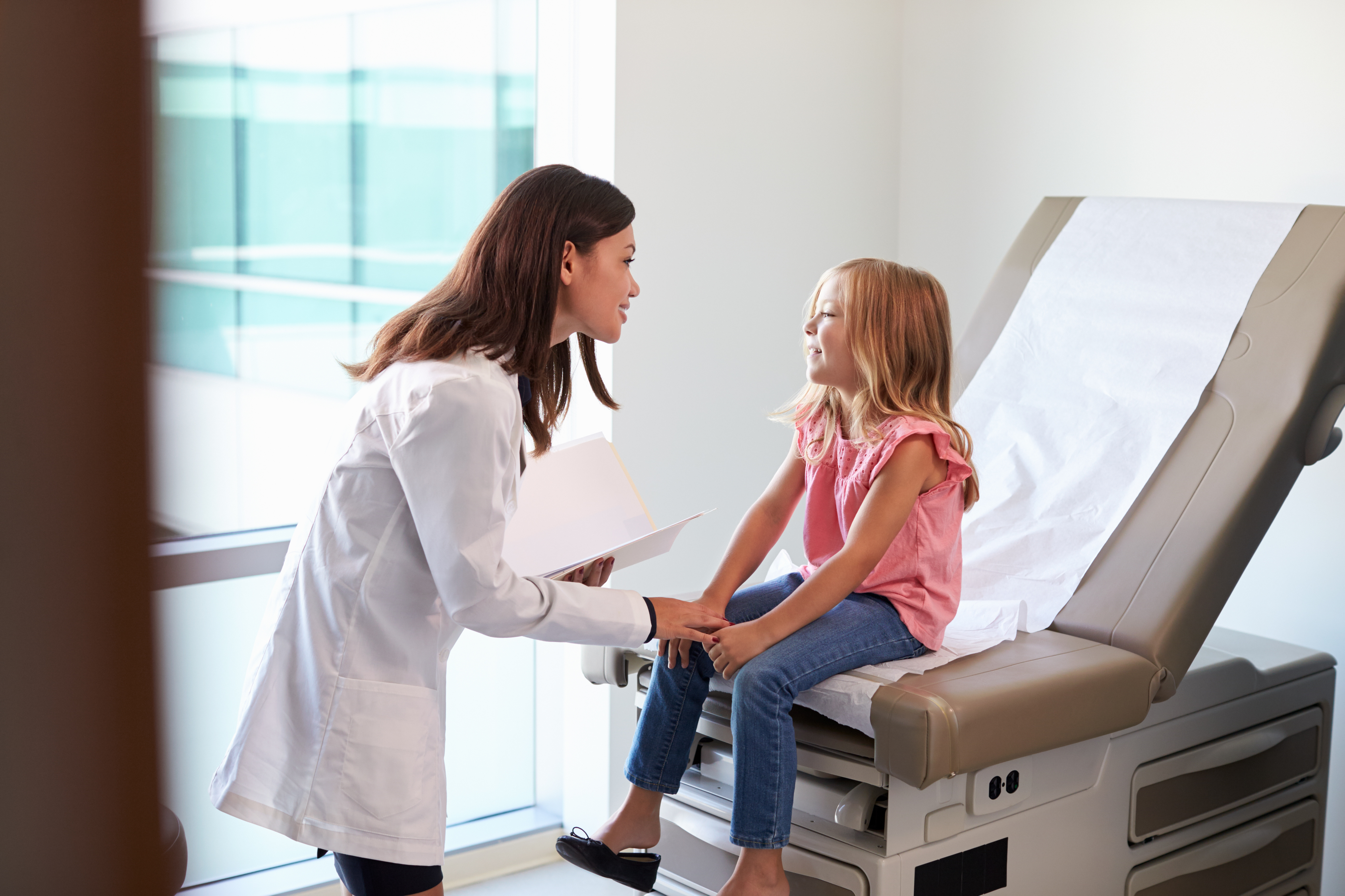 pediatrician with child in exam room