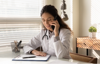 a woman in an office setting talks on the phone