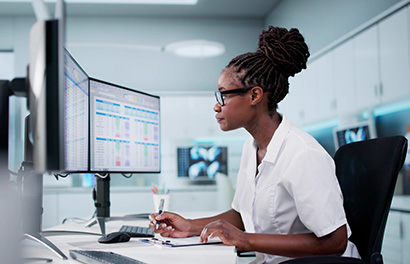 a young black woman works at a computer