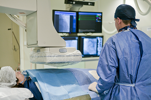 vascular surgeon with patient in cath lab